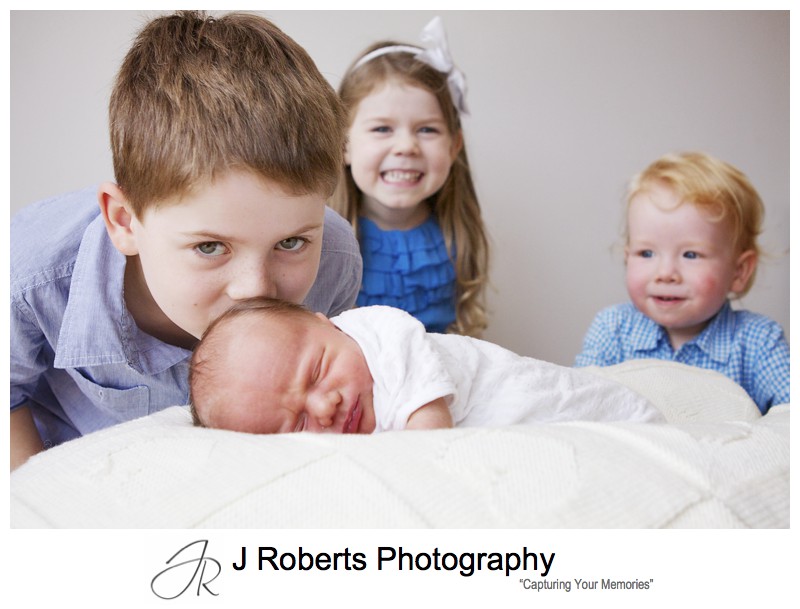 Bug brother kissing newborn babies head - newborn baby portrait photography sydney